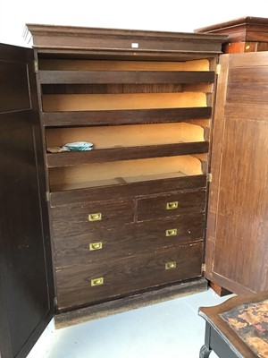 Lot 123 - Antique oak wardrobe with two panelled doors enclosing four sliding drawers two short and two long drawers on plinth base