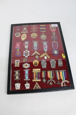 Lot 2016 - A glass case containing 23 assorted Masonic jewels and pins