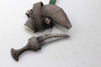 Lot 349 - Old Arab Jambia Silver mounted dagger with horn hilt, curved blade with central rib in sheath with silver bullion belt.