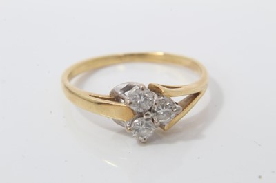 Lot 166 - Gold three stone diamond cluster ring