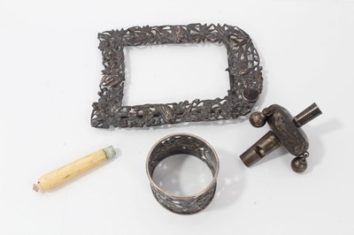 Lot 255 - 19th century Chinese white metal photograph frame, babies rattle and napkin ring (3)