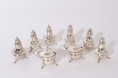 Lot 328 - George V silver cruet set of cauldron form, raised on three splayed paw feet, comprising two mustard pots, two pepperettes and two salt casters (Birmingham 1926), all at 8.5oz (8 pieces)