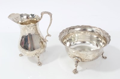 Lot 203 - Silver cream jug and matching sugar bowl with pie crust edges