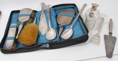 Lot 220 - Two silver topped cut glass scent bottles together with a silver vanity set in case and silver handled serving implements