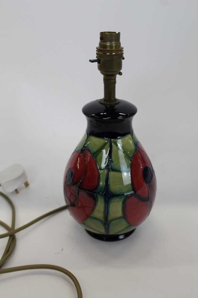 Lot 840 - Moorcroft pottery table lamp decorated with a red flower on blue and green ground