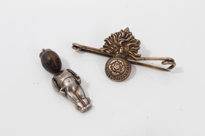 Lot 261 - Fumsup good luck charm and silver gilt Royal Fusiliers bar brooch