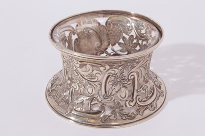 Lot 222 - Edwardian silver dish of small proportions with pierced animal, scroll and foliate decoration, with clear glass liner, (Chester 1901), Maker George Nathan & Ridley Hayes, all at 1.5oz, 8cm in diameter