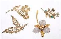 Lot 619 - Four 9ct gold floral spray brooches