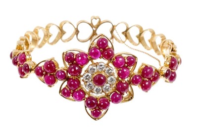 Lot 409 - Ruby and diamond hinged bangle with cabochon rubies and brilliant cut diamonds