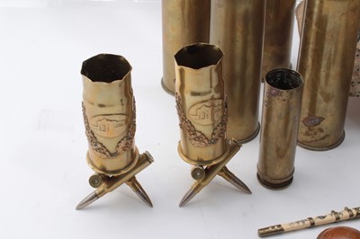 Lot 218 - Pair of First World War brass trench art vases marked Ypres, raised on bases constructed from bullets, together with other brass trench art vases, two carved nut Netsukes