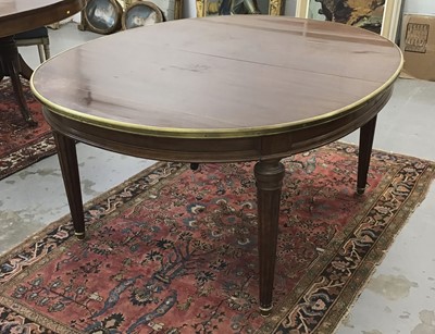 Lot 1000 - 19th century French mahogany and brass mounted extending dining table of oval form, minus extending leaves