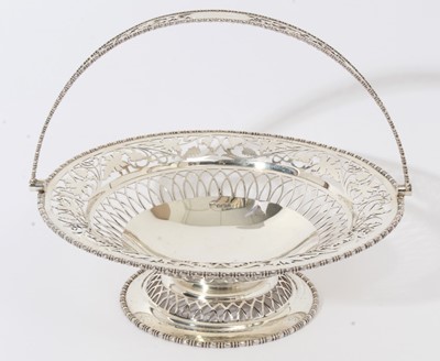 Lot 269 - George V silver cake basket of circular form with pierced foliate decoration, egg and dart borders and swing handle, raised on a circular pedestal base, (Sheffield 1912)