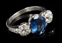 Lot 637 - Sapphire and diamond three-stone ring with an...