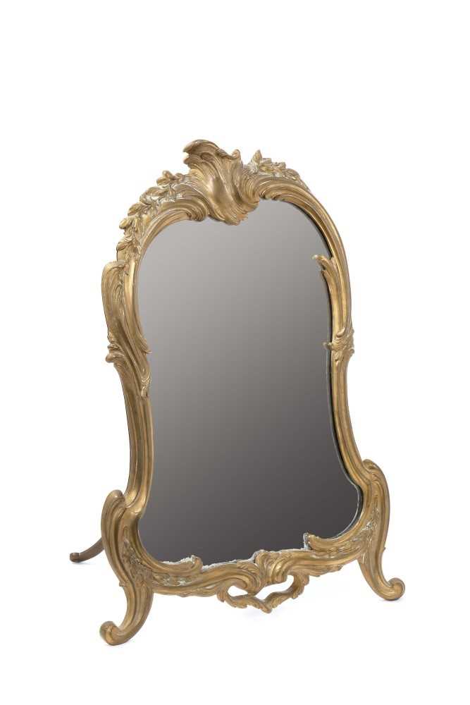 Lot 1315 - 19th century brass rococo easel dressing table mirror of asymmetric cartouche form, 55cm high