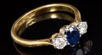 Lot 638 - Sapphire and diamond three-stone ring with a...