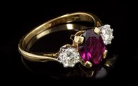 Lot 640 - Rhodolite garnet and diamond three-stone ring...