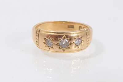 Lot 523 - 18ct gold three stone diamond ring