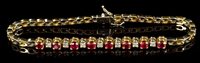 Lot 653 - Ruby and diamond bracelet with eight round...