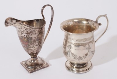 Lot 203 - Edwardian silver cream jug of helmet form with loop handle (Birmingham 1905) together with a 1920's silver christening mug (Birmingham 1929)