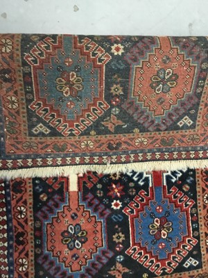 Lot 882 - Three rugs to include a Keshan rug with central medallion on red ground 180cm x 91cm, Persian rug 94cm x 55cm and a rug on pale red ground 205cm x 122cm