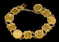 Lot 665 - Antique Chinese yellow metal bracelet with ten...