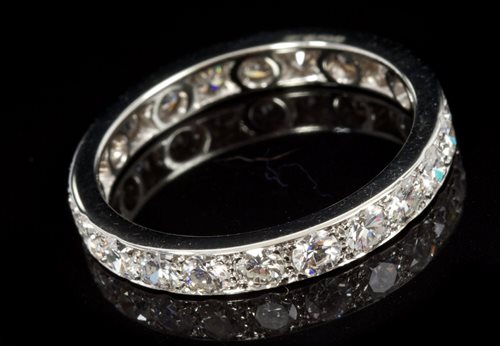 Lot 673 - Diamond eternity ring with a full band of...