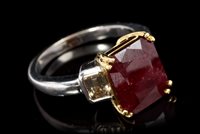 Lot 677 - Ruby and diamond three-stone ring with a...