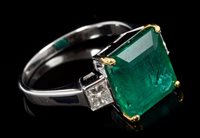 Lot 682 - Emerald and diamond three-stone ring with a...