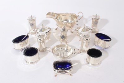 Lot 352 - Group of silver condiments to include five salts with blue glass liners, two pairs of pepperettes, pair of silver mustard pots, single pepperette and five silver spoons