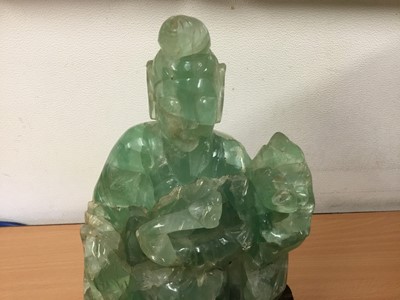 Lot 290 - Oriental carved hardstone sculpture of a seated figure and dog of Fo, on carved hardwood base, 24cm high