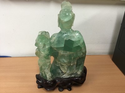 Lot 35 - Oriental carved hardstone sculpture of a seated figure and dog of Fo, on carved hardwood base, 24cm high