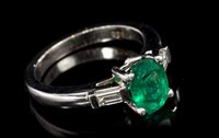 Lot 685 - Emerald and diamond three-stone ring with an...