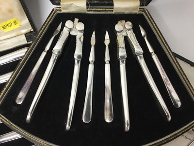 Lot 294 - Two set of six silver coffee spoons, two set of six silver handled tea knives in fitted case and a nut cracker set in case