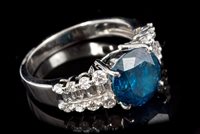 Lot 688 - Fancy blue diamond ring, the central round...