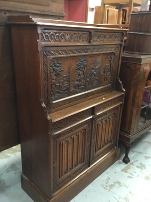 Lot 1001 - Edwardian carved oak escritoire with fall flap carved with figures emblematic of the seasons, four drawers and two linen fold carved doors below 96cm wide, 135 cm high, 37 cm deep.