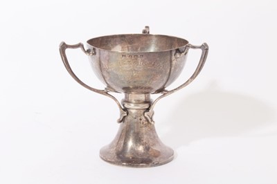 Lot 298 - Edwardian silver trophy cup in the Art Nouveau style with three handles, flared column and pedestal foot, engraved presentation inscription (Birmingham 1906), 7.5ozs, 12.5cm in height