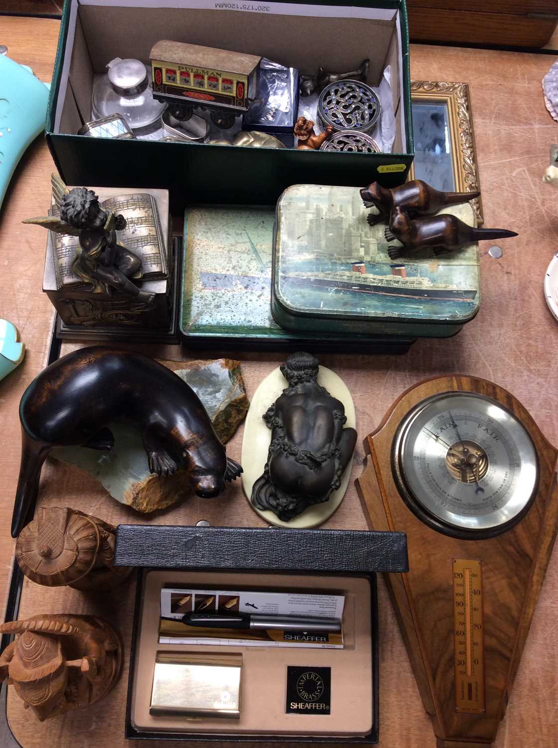 Lot 414 - Wall barometer, wooden otter ornaments, old tins, leather map and sundries