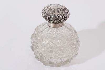 Lot 233 - Edwardian cut glass scent bottle, of globular form with hobnail cut decoration and star cut base, silver screw fit top with embossed scroll decoration, (Chester 1902), maker William Neale and Son