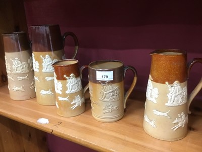 Lot 179 - Four Doulton Lambeth stoneware jugs and a similar tankard