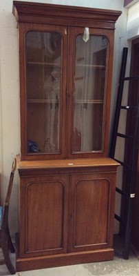 Lot 873 - Victorian mahogany two height bookcase with two glazed doors above enclosing adjustable shelves and two panelled doors below