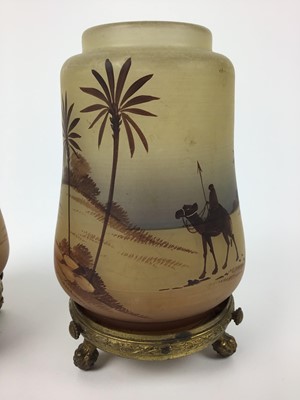 Lot 24 - Pair of small glass nightlights decorated with Egyptian scenes on gilt metal stands