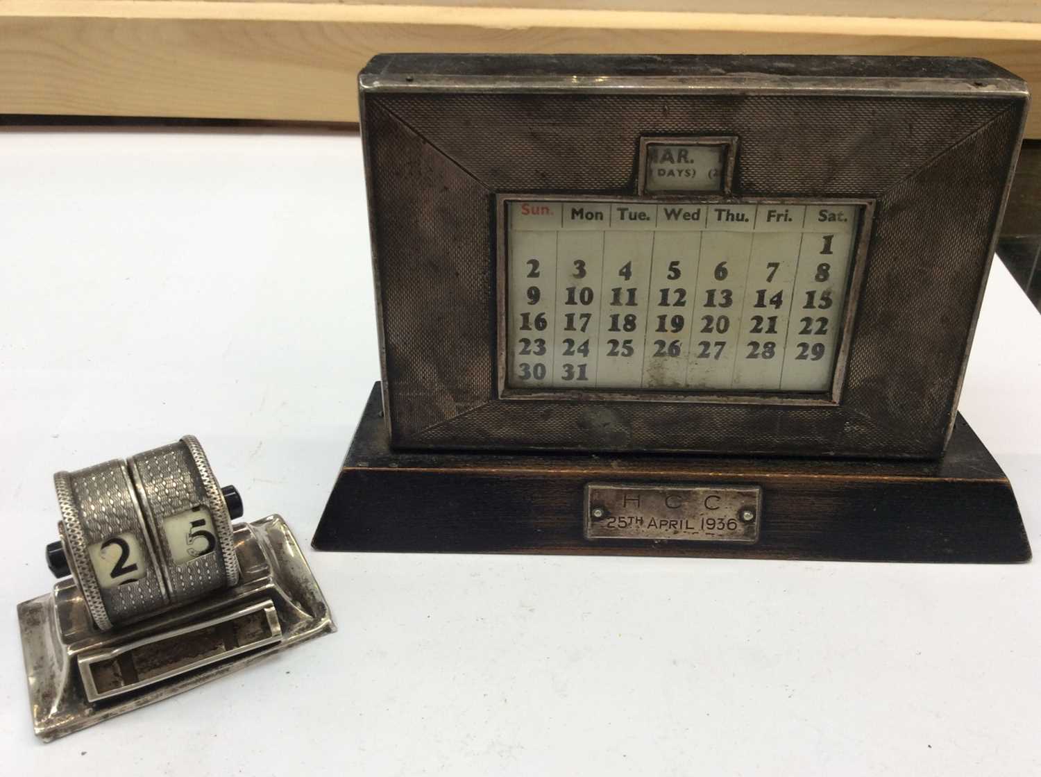 Lot 677 - Silver framed wooden desk calendar and silver rotating desk calendar