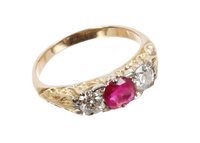 Lot 744 - Ruby and diamond three-stone ring with round...