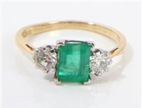 Lot 745 - Emerald and diamond three-stone ring with a...