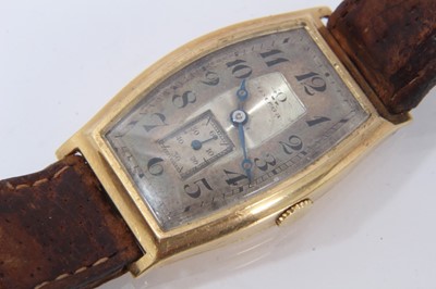 Lot 615 - 1920s mid-size Omega 18ct gold wristwatch with tonneau shape gold case, import hallmarks for Edinburgh 1928, on brown leather strap