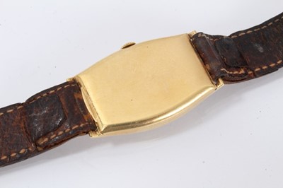 Lot 615 - 1920s mid-size Omega 18ct gold wristwatch with tonneau shape gold case, import hallmarks for Edinburgh 1928, on brown leather strap