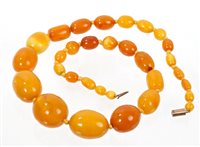 Lot 753 - Old amber bead necklace with a string of...