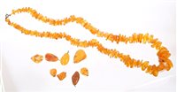 Lot 754 - Amber necklace with free-form beads and eight...