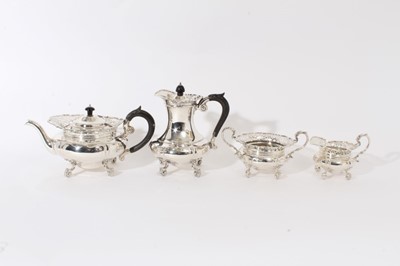 Lot 258 - Fine quality Edwardian silver four piece tea and coffee set - comprising teapot of cauldron form, with pierced borders, raised on four shell and scroll feet