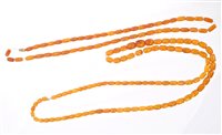 Lot 761 - Two strings of graduated amber beads, length...